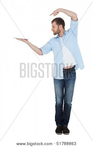 Serious model holding laptop on right hand with flair and looking at it 