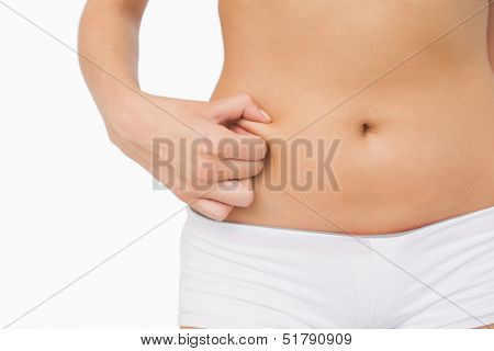 Slim woman with little fat on her belly on white screen