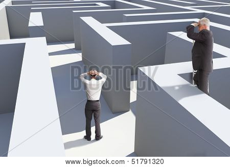Two businessmen standing in maze being captured
