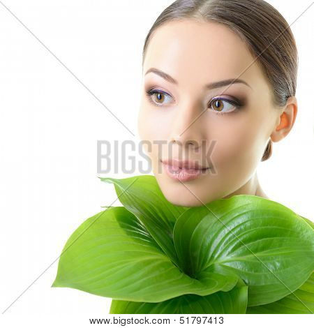 beautiful yoiung cheerful woman with green leaves near her face, care of nature concept, over white background