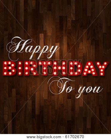 Parquet floor background with glowing letters writing Happy Birthday to you