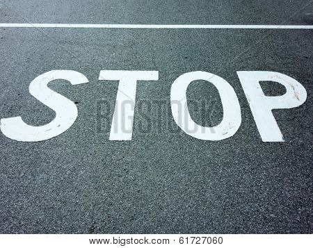 the inscription stop on a road. stopping at an intersection because of stop sign.