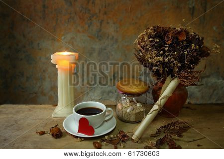 Still Life Cup Of Love,candle, Dry Roses And Grunge Paper On Wooden Table
