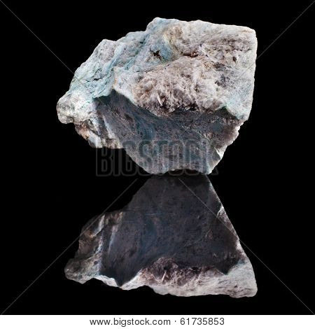 Dumortierite mineral with reflection on black surface background 
