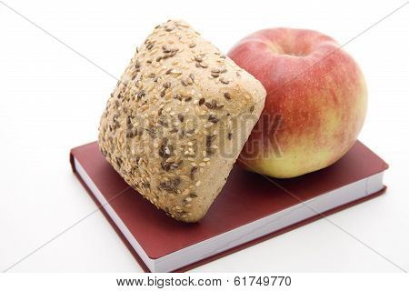 Fresh Red Apple with Baked Grain Bread Roll