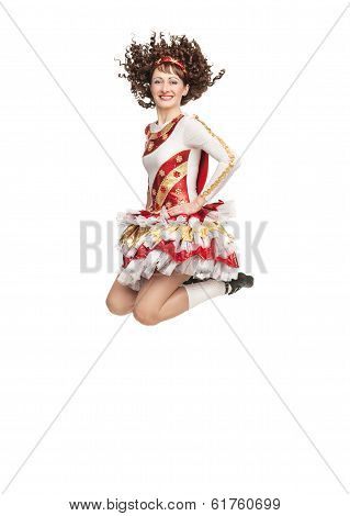 Young Woman In Irish Dance Dress Jumping