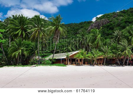 Paradise beach with bungalows and mountains