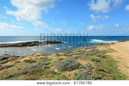 Rocky Shore And Clouds