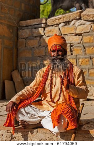 JAISALMER, INDIA - NOVEMBER 28, 2012: Indian sadhu (holy man) blessing. Sadhus are holy men who live ascetic life and focus on spiritual practice of Hinduism
