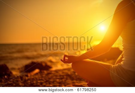 Hand Of  Woman Meditating In A Yoga Pose On Beach At Sunset