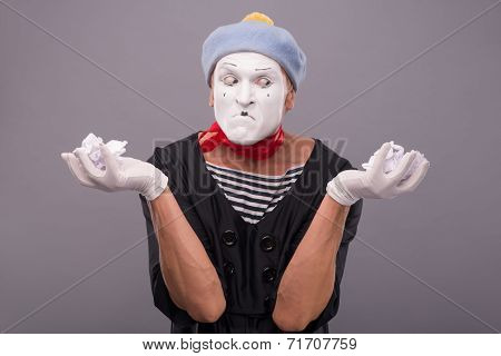 Portrait of funny male mime with grey hat and white face isolate