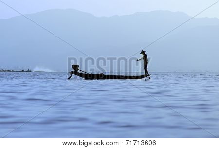 Traveling to Myanmar, outdoor photography of fisherman on traditional boat. Intha people from Shan state of Burma
