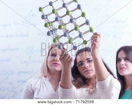 happy young teens group in school on chemisty lessons and library education