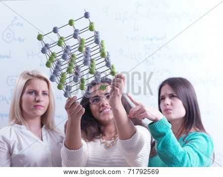 happy young teens group in school on chemisty lessons and library education