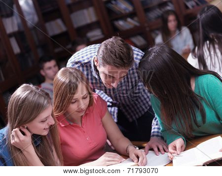 happy young teens group in school on chemisty lessons and library education
