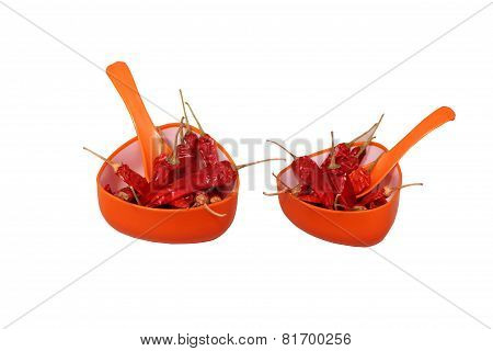Dried Reddish Spicy Chilly in orange cup with spoon