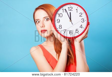 Redhead Girl With Huge Clock On Blue Background.
