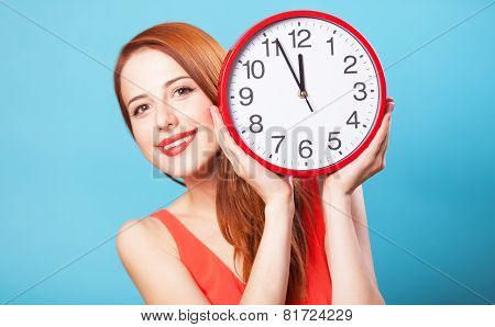 Redhead Girl With Huge Clock On Blue Background.
