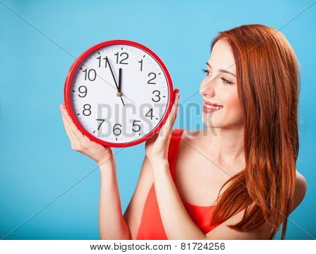 Redhead Girl With Huge Clock On Blue Background.