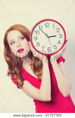 Surprised Redhead Girl With Huge Alarm Clock On Light Background.