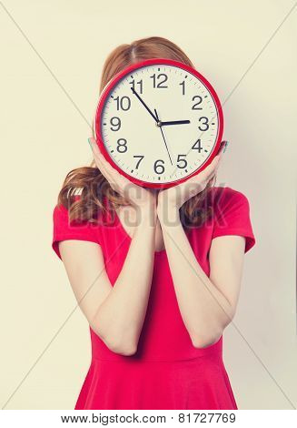 Surprised Redhead Girl With Huge Alarm Clock On Light Background.