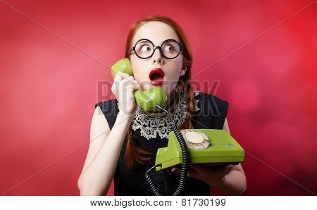 Redhead Girl With Green Phone On Red Background.