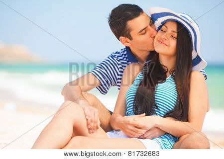 Beautiful Couple Kissing On The Beach.