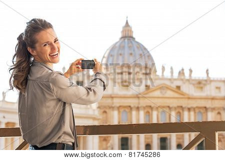 Portrait Of Happy Young Woman Taking Photo Of Basilica Di San Pietro In Vatican City State