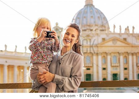 Happy Mother And Baby Girl With Photo Camera On Piazza San Pietr