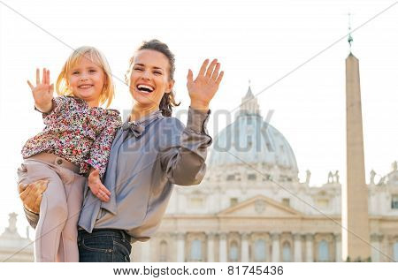 Portrait Of Happy Mother And Baby Girl Waving In Front Of Basili