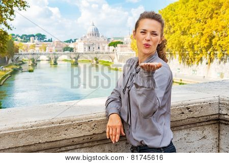 Young Woman Blowing Kiss From Ponte Umberto I With View On Basil