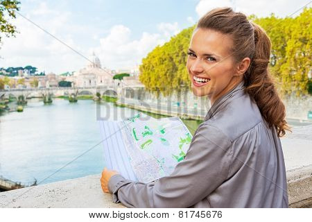 Portrait Of Smiling Young Woman With Map On Bridge Ponte Umberto
