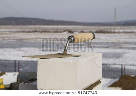 Building. Trowel lies on silica brick