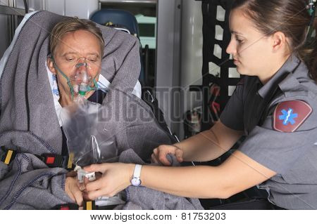 Paramedic employee with ambulance in the background.