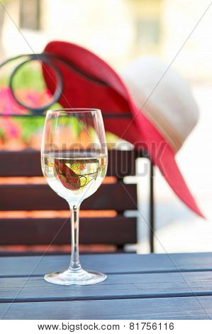 Glass Of Delicious White Wine In Summer Restaurant. Outdoors.
