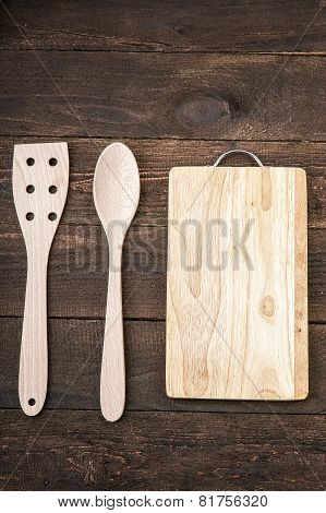 Wooden kitchenware and cutting board on the old table
