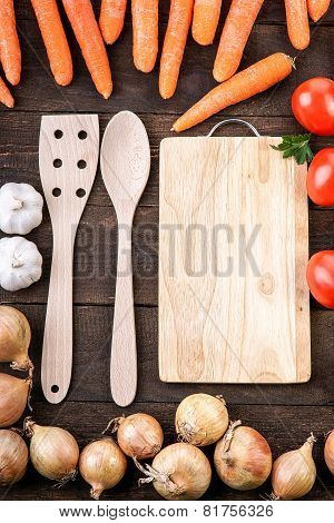 Vegetables around the wooden kitchenware