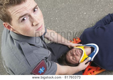 Paramedic employee with ambulance in the background.