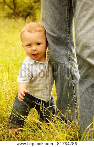 a little boy with his father on the nature