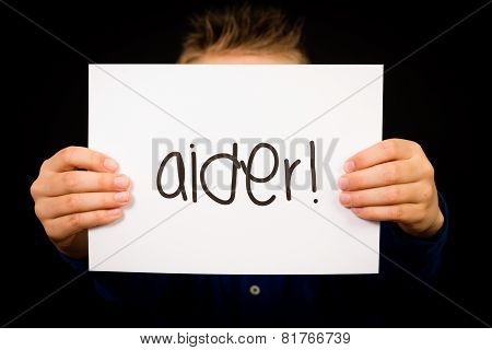 Child Holding Sign With French Word Aider - Help