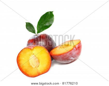 Heap Of Plums With Green Leaf. Isolated.
