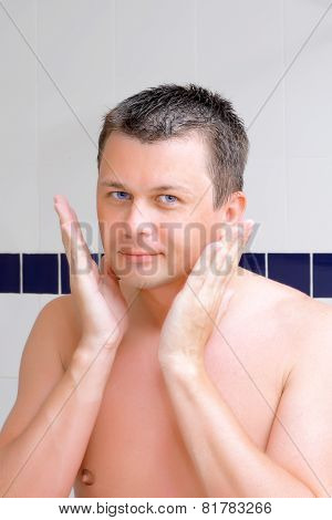 A Young Man Uses A Lotion After Shaving.