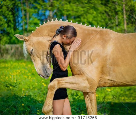 Girl hugging a horse