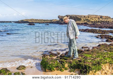 Senior tourist visiting beach in Oualidia, Atlantic coast of Morocco