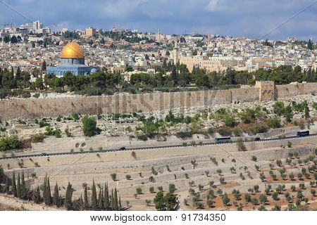 The ancient Jewish cemetery on the Mount of Olives on the background of the old quarters of Jerusalem. Seen the Golden Dome Mosque Dome of the Rock 