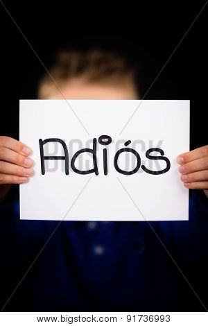 Child Holding Sign With Spanish Word Adios - Goodbye