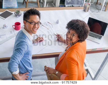 Two desingers working on a project together in office