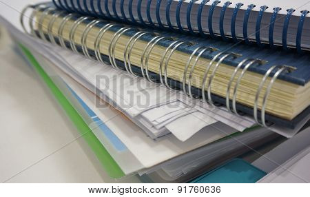 Stack Of Office Document And Ring Binder Book On Desk