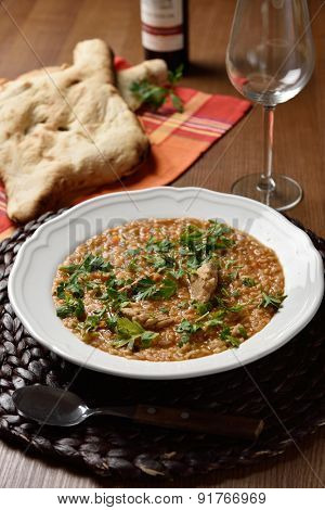 Soup Kharcho, the traditional Georgian soup with meat and rice served with lavash flat bread and wine
