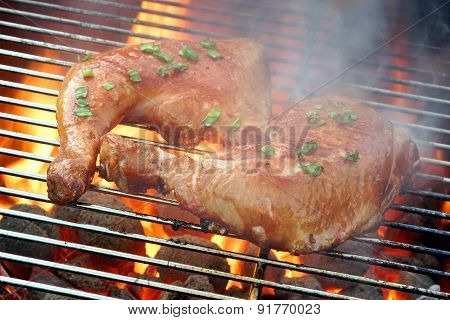 Two Chicken Quarter On The Hot Bbq Grill Close-up.